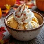 Bowl of pumpkin ice cream with fall decorations