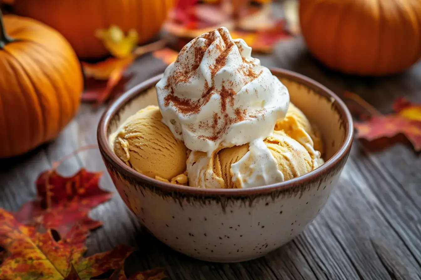 Bowl of pumpkin ice cream with fall decorations