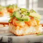 Spicy salmon crispy rice served on a bright marble table.