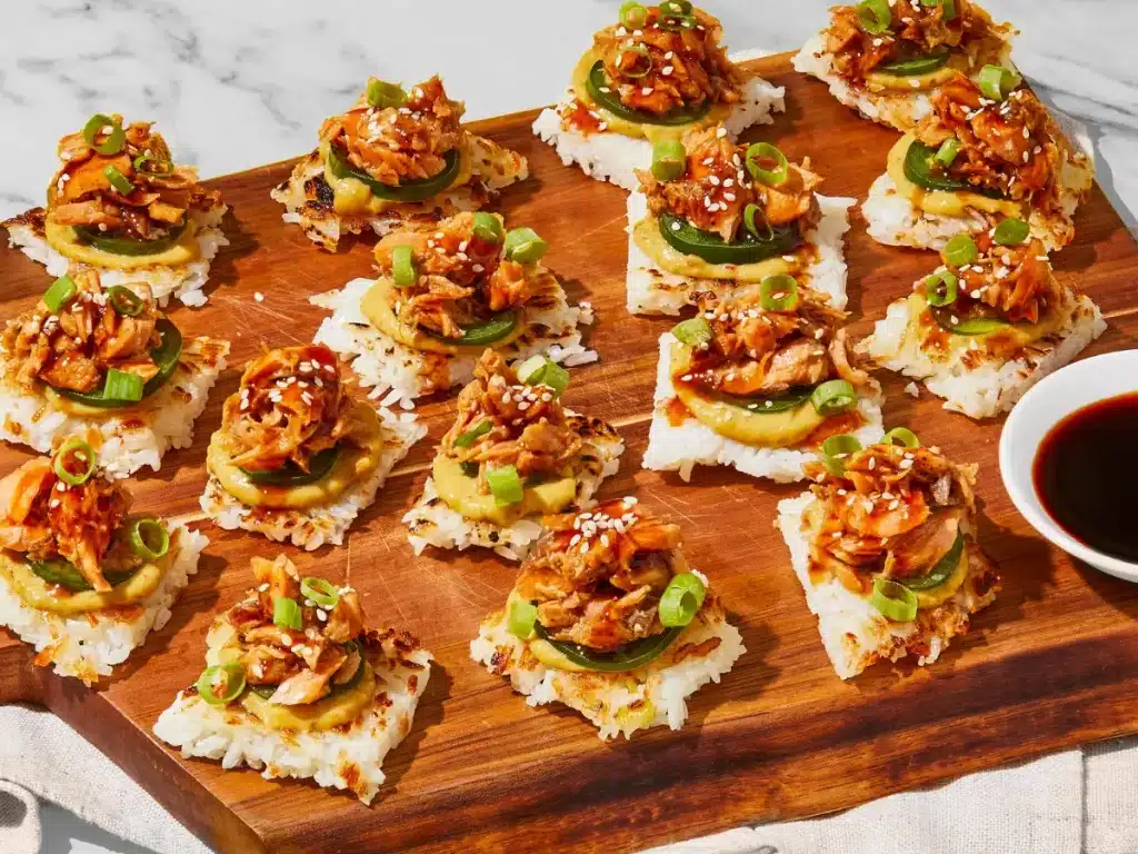 Spicy Salmon Crispy Rice – A Flavor-Packed Appetizer You’ll Crave 5 Spicy salmon rice bites served with cucumber salad, edamame, and dipping sauces