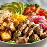 High protein burger bowl with lean beef, vegetables, potatoes, and creamy yogurt sauce