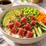 Ahi tuna poke bowl with fresh tuna, avocado, cucumber, edamame, and sesame rice