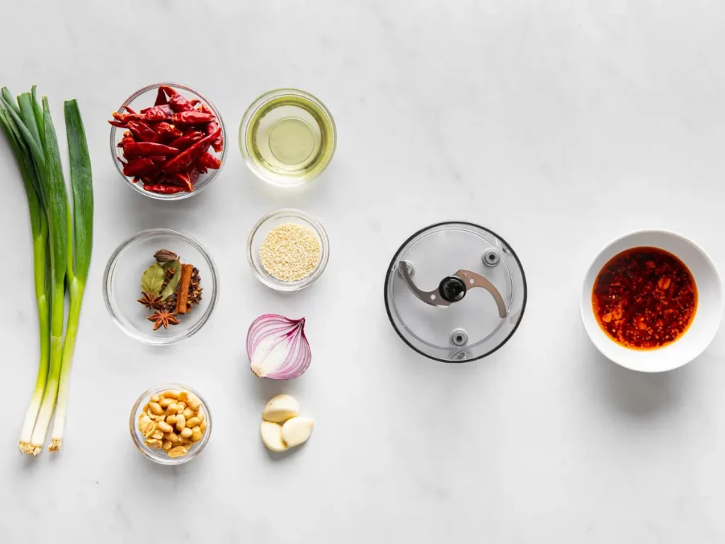 Garlic, shallots, chili flakes, sesame seeds, and oil arranged for homemade chili crunch